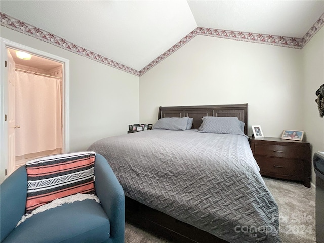 carpeted bedroom featuring lofted ceiling