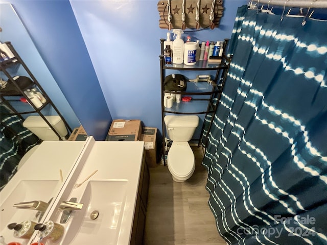 bathroom featuring hardwood / wood-style flooring and toilet