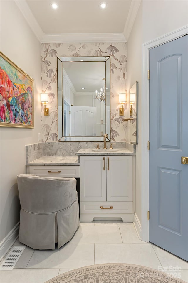 bathroom featuring tile patterned flooring, crown molding, vanity, and baseboards