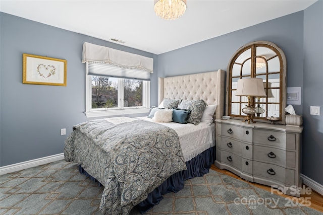 bedroom with visible vents and baseboards