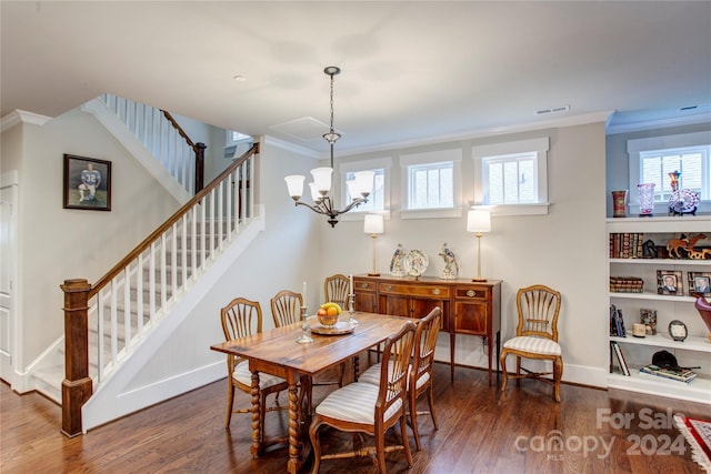 dining area featuring dark hardwood / wood-style flooring, crown molding, and plenty of natural light