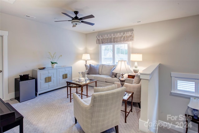 carpeted living room with ceiling fan