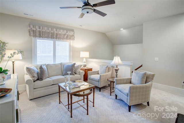 living room with lofted ceiling, light carpet, and ceiling fan