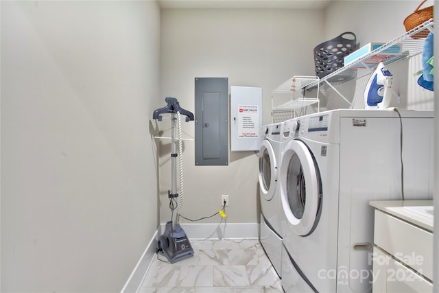 clothes washing area featuring electric panel and washer and dryer