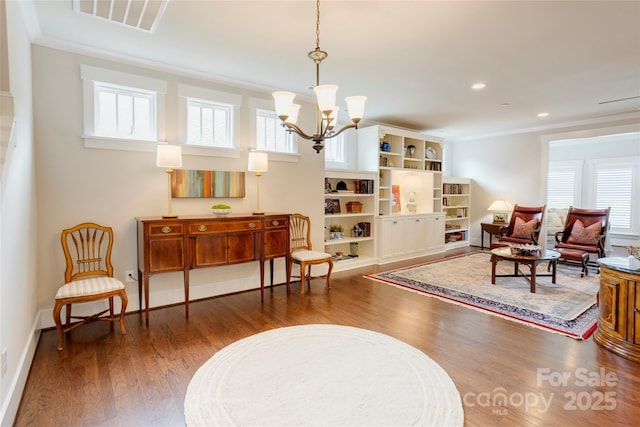 sitting room featuring a wealth of natural light, wood finished floors, and visible vents