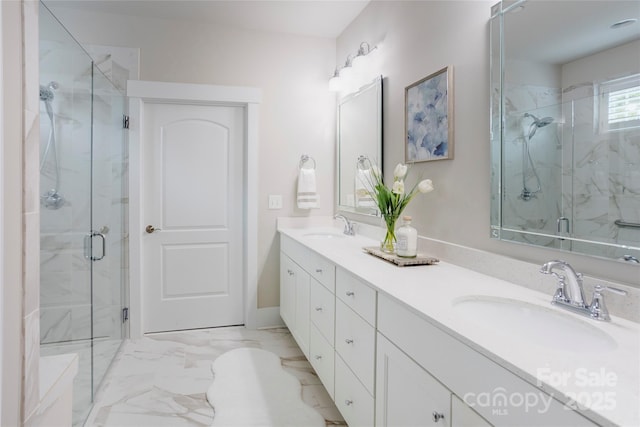 bathroom with a marble finish shower, a sink, double vanity, and marble finish floor