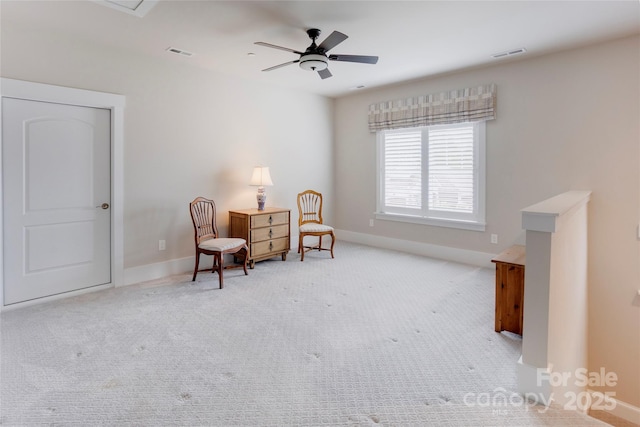 living area with baseboards, visible vents, a ceiling fan, and carpet flooring