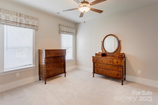 sitting room featuring baseboards, visible vents, light carpet, and a ceiling fan