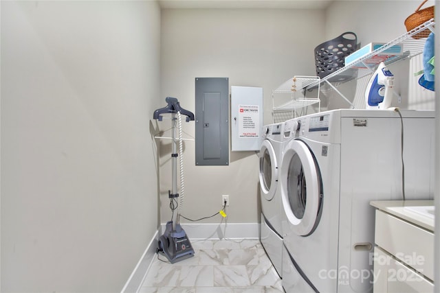 laundry area featuring washer and clothes dryer, electric panel, laundry area, marble finish floor, and baseboards