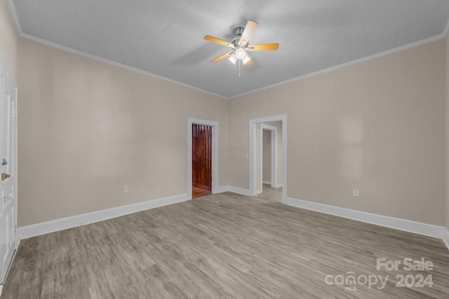 empty room with ceiling fan, ornamental molding, and light hardwood / wood-style flooring