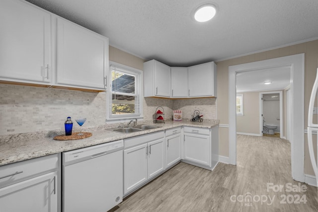 kitchen featuring white dishwasher, white cabinets, crown molding, sink, and light wood-type flooring