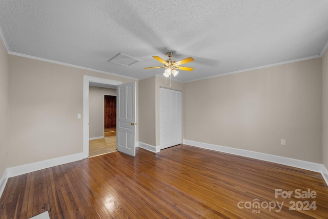 unfurnished room featuring dark hardwood / wood-style floors, crown molding, and a textured ceiling