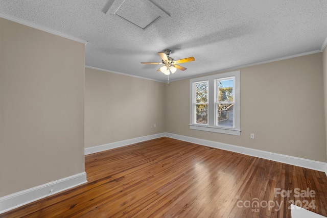 empty room featuring wood-type flooring, a textured ceiling, ceiling fan, and ornamental molding