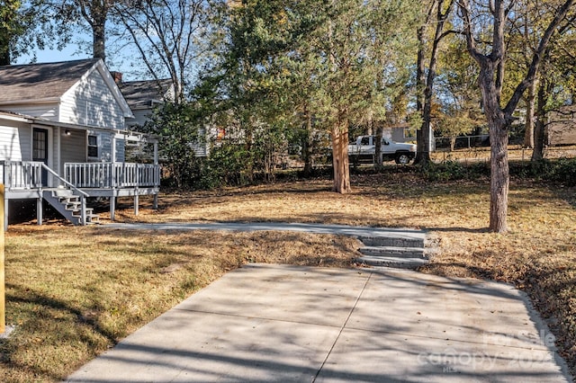 view of yard with a patio area and a wooden deck