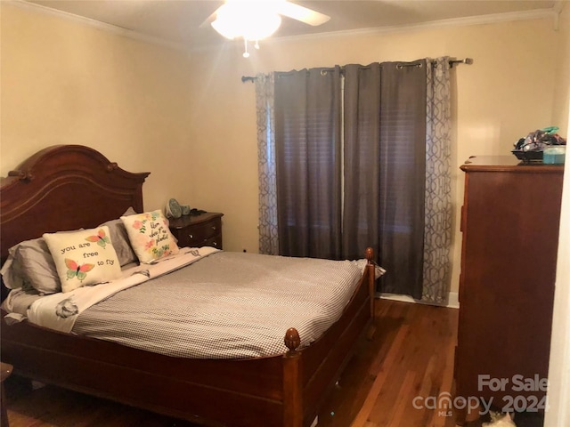 bedroom with crown molding, ceiling fan, and dark hardwood / wood-style floors