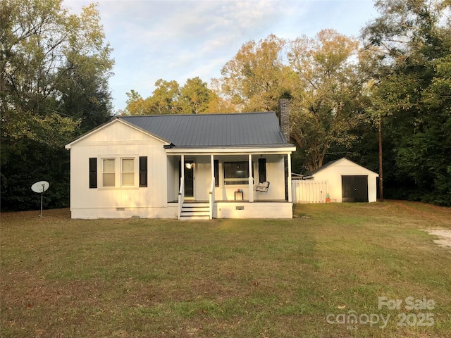 view of front facade featuring metal roof, a chimney, crawl space, a front yard, and a porch