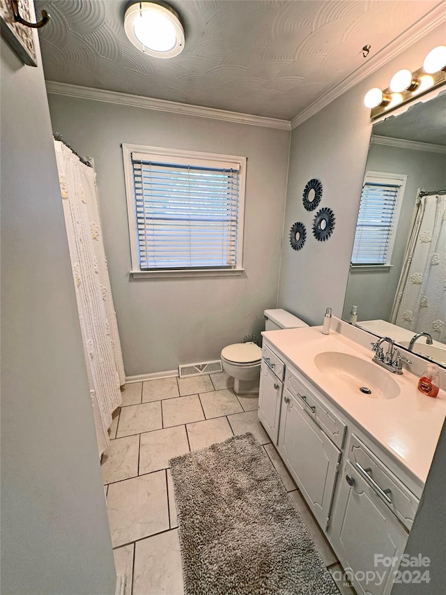 bathroom with tile patterned floors, a wealth of natural light, vanity, and ornamental molding