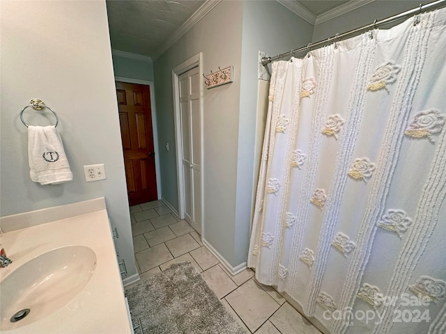 bathroom featuring a shower with shower curtain, tile patterned floors, crown molding, and sink