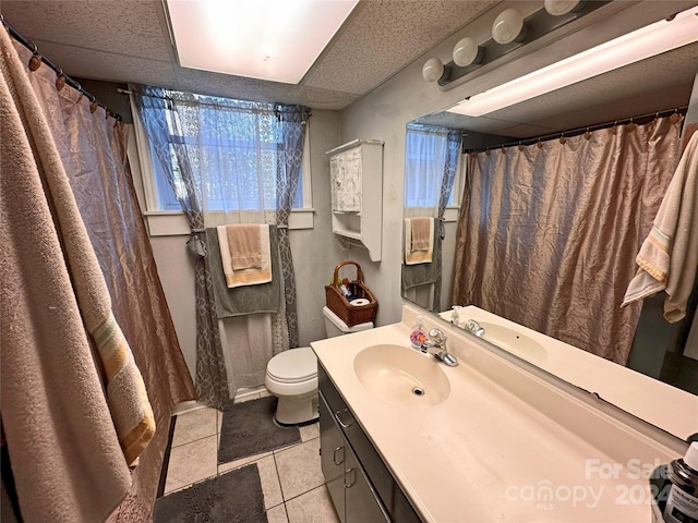 bathroom featuring tile patterned flooring, vanity, and toilet