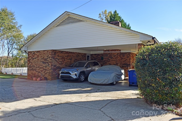 view of vehicle parking with a carport