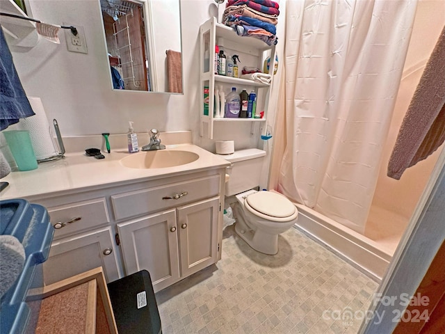 bathroom featuring vanity, a shower with shower curtain, and toilet