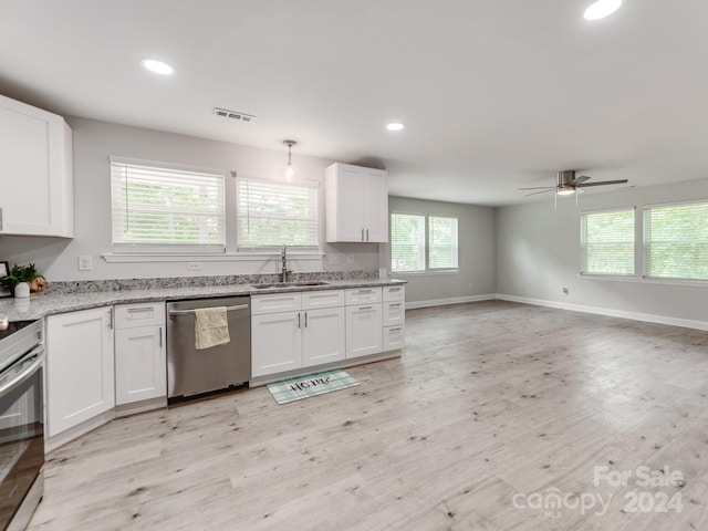 kitchen featuring white cabinets, appliances with stainless steel finishes, sink, and light hardwood / wood-style flooring