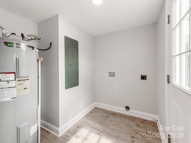 laundry room featuring electric panel, light hardwood / wood-style floors, electric dryer hookup, water heater, and washer hookup