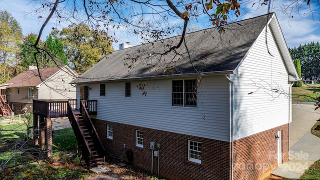 rear view of property featuring a wooden deck