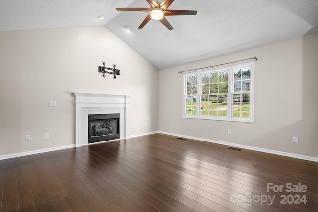 unfurnished living room with hardwood / wood-style flooring, ceiling fan, a textured ceiling, a tile fireplace, and vaulted ceiling