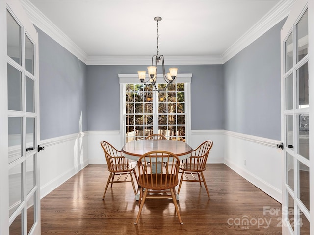 dining room featuring dark hardwood / wood-style flooring, a notable chandelier, and crown molding