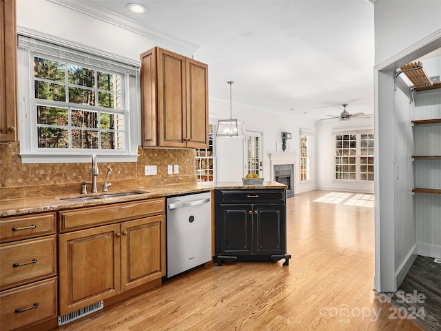 kitchen with light hardwood / wood-style floors, dishwasher, sink, ceiling fan, and backsplash