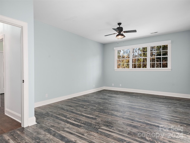 spare room featuring dark wood-type flooring and ceiling fan