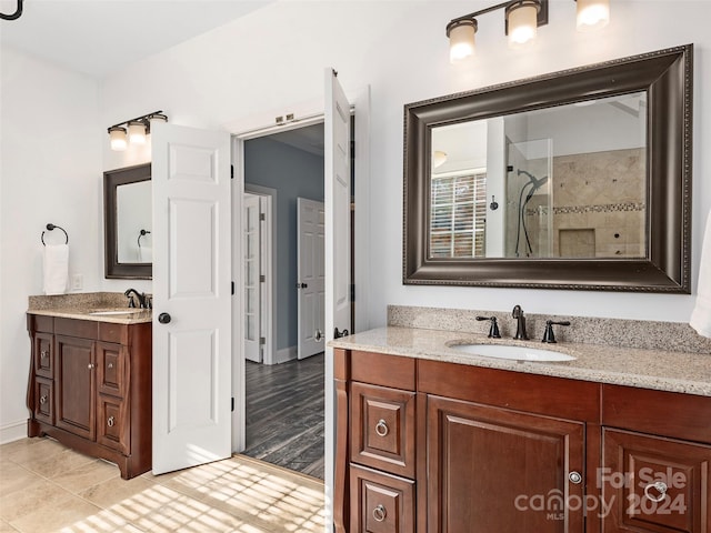 bathroom with wood-type flooring, vanity, and a shower