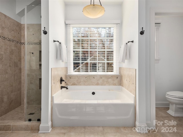 bathroom with toilet, plus walk in shower, and tile patterned floors