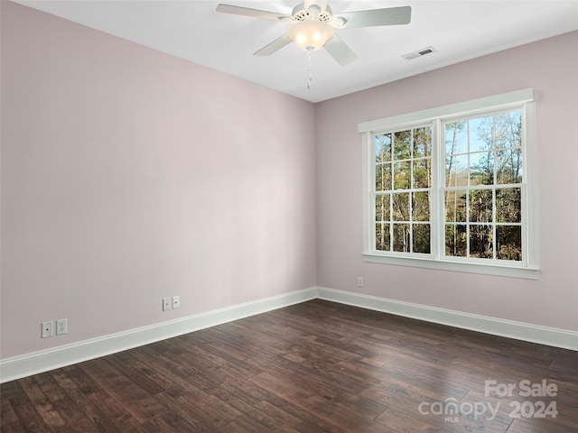 spare room with dark wood-type flooring and ceiling fan