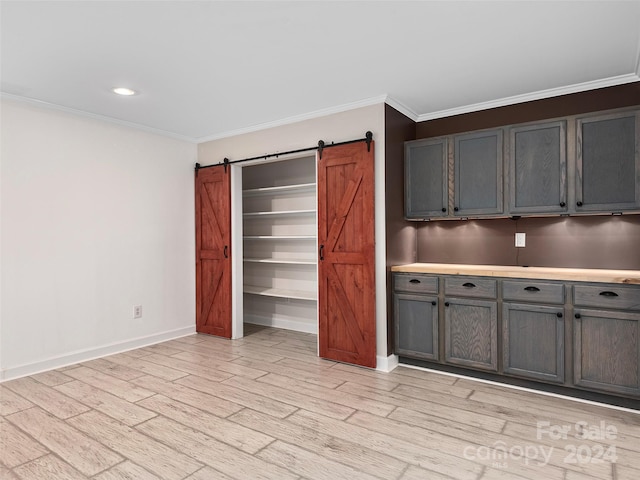 interior space featuring ornamental molding and light hardwood / wood-style floors