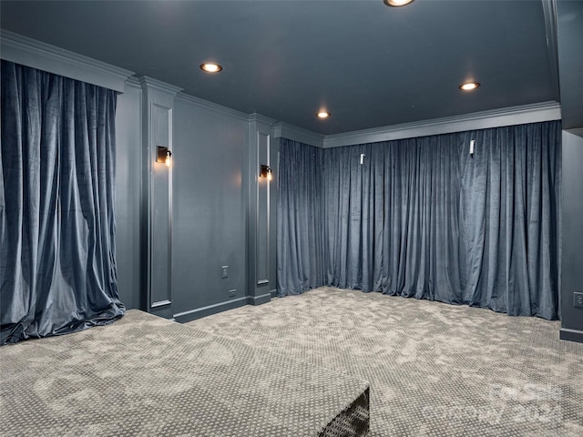 home theater with ornamental molding and carpet floors