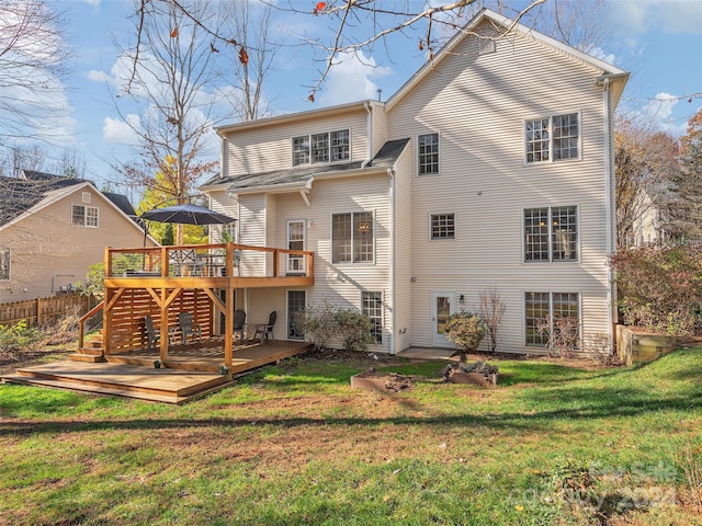 back of property featuring a yard and a deck