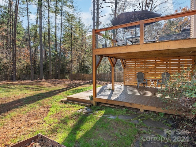 wooden deck with a lawn