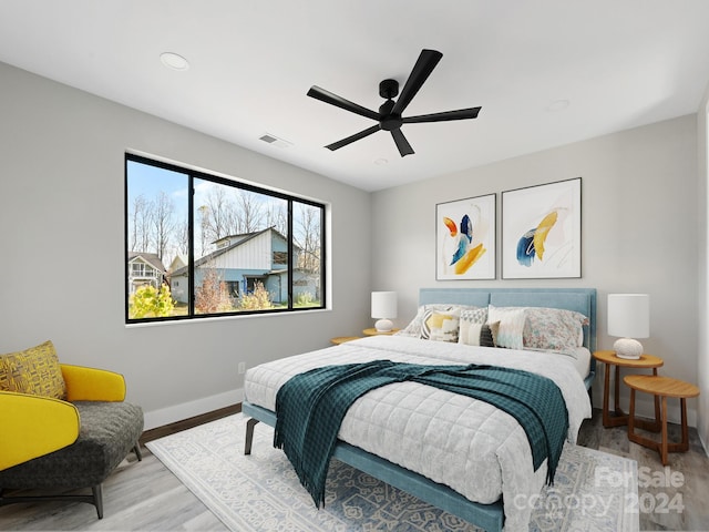 bedroom featuring light wood-type flooring and ceiling fan