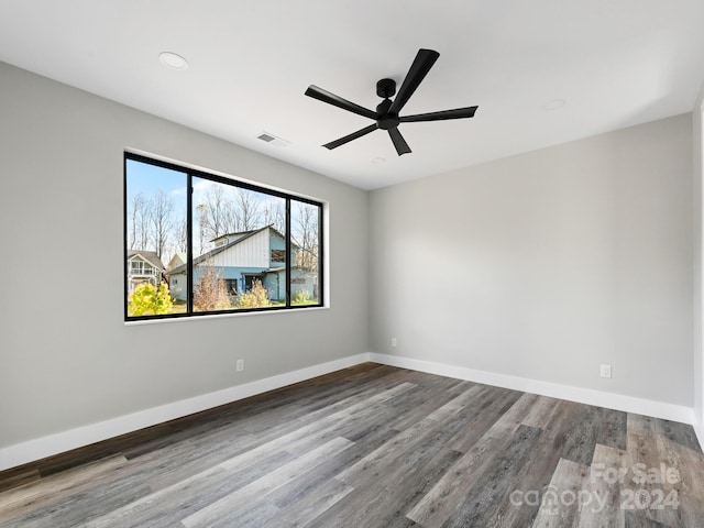 unfurnished room with hardwood / wood-style flooring and ceiling fan