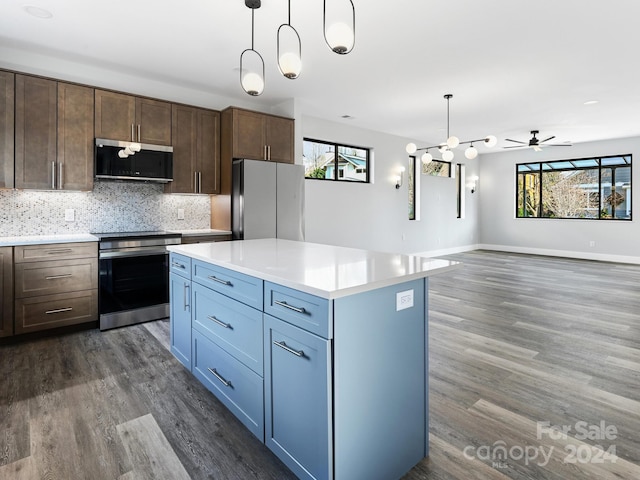 kitchen featuring pendant lighting, a wealth of natural light, and stainless steel appliances