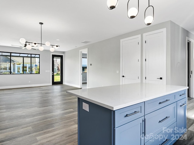 kitchen with pendant lighting, dark hardwood / wood-style flooring, and a kitchen island