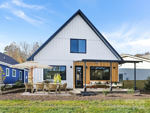 back of property featuring a lawn, outdoor lounge area, and a patio