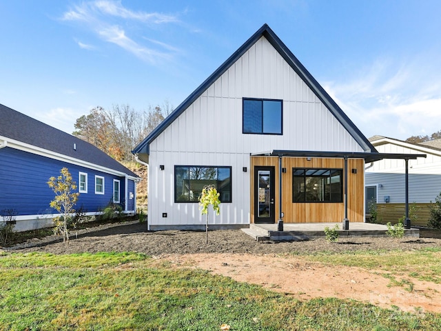 back of house with a lawn