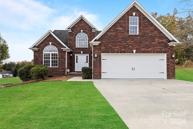 view of front property with a garage and a front yard