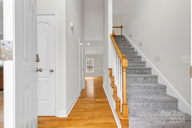 staircase with wood-type flooring