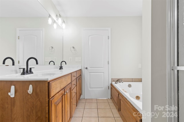 bathroom featuring vanity, a tub, and tile patterned floors