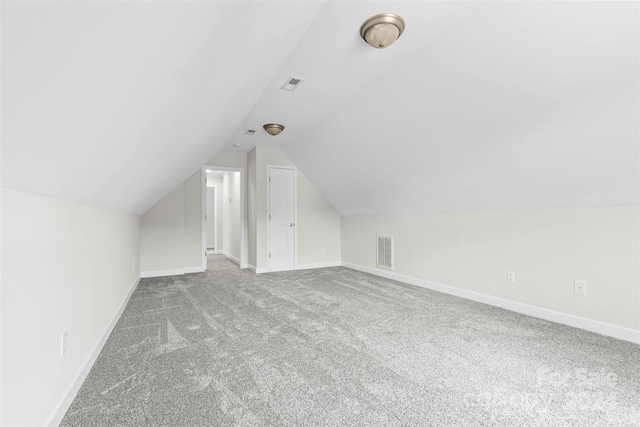 bonus room featuring lofted ceiling and carpet