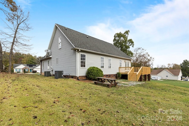 rear view of house featuring central AC, a lawn, and a wooden deck